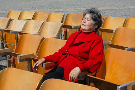 elderly woman relaxing on bench in lonelinessの写真素材