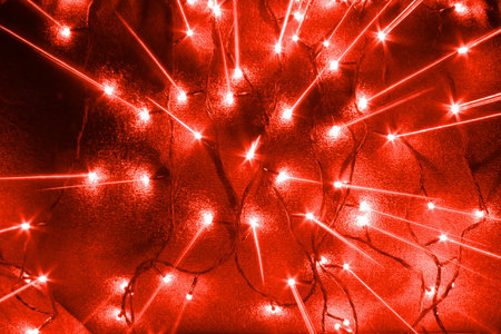 abstract new year garlands bulb lights and scattering from center rays background