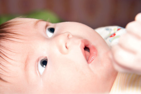 infant about two month wondering eyes closeup face