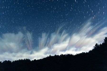 Clouds and night sky star trails