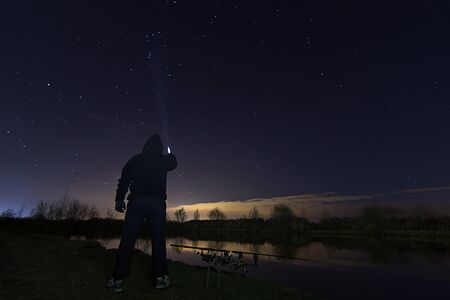 Fisherman in Starry Night, Pointing to Orion the Hunter Constellation , patience.の写真素材