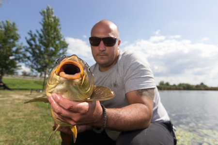 Angler with carp fishing trophy Carp and Fisherman, Carp fishing trophyの写真素材