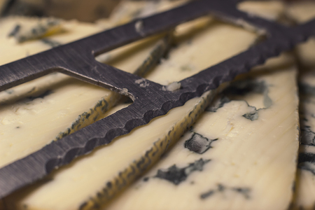 Blue cheese close up on an old wooden board and a knife Selective focusの写真素材