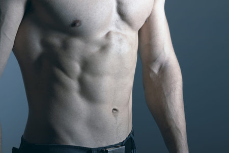 Fitness Model Torso showing. Man with muscular torso. Muscular man in the fitness club.