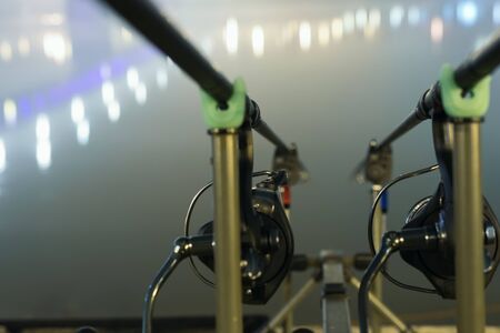 Carp spinning reel angling rods in foggy night. Urban Edition. Night Fishing, Carp Rods, City lights. Foggy night.の写真素材