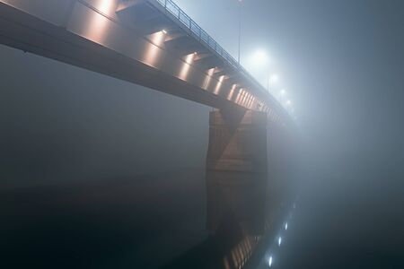 Bridge in the fog. Night Bridge Thick Fog. Night shot of a bridge in thick fog.の写真素材