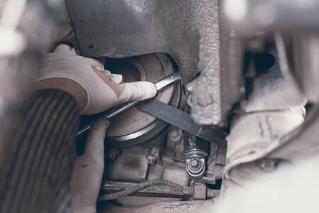 Hands of car mechanic in auto repair service.の写真素材