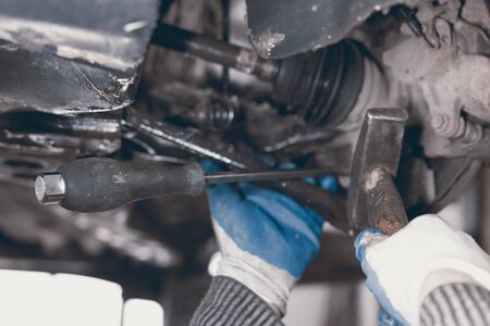 Hands of car mechanic in auto repair service.の写真素材