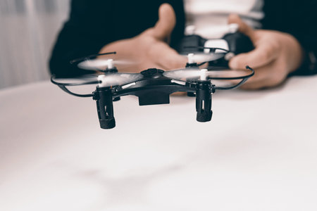 Boy Playing With A Small Quadrocopter Drone Close-up.の写真素材