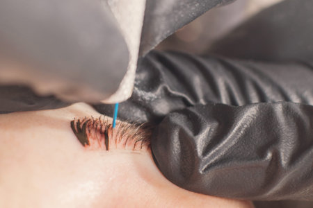 Cosmetologist applying permanent make up on eyebrows. Permanent tattooing of eyebrows.