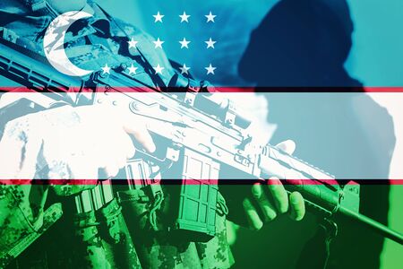 Soldier with machine gun with national flag of Uzbekistanの写真素材