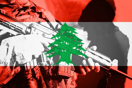 Soldier with machine gun with national flag of Lebanonの写真素材
