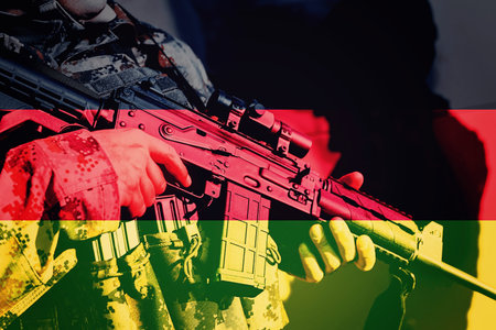 Soldier with machine gun with national flag of Germany