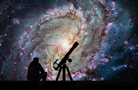 Man with telescope looking at the stars. Messier 83, Southern Pinwheel Galaxy, M83 in the constellation Hydra.Elements of this image are furnished by NASA.の写真素材