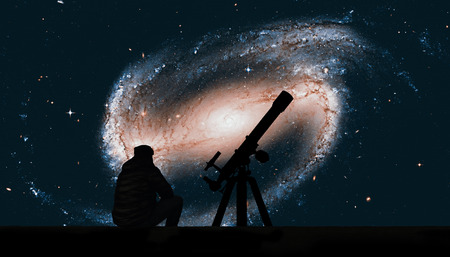 Man with telescope looking at the stars. Spiral galaxy in the constellation Eridanus NGC 1300.の写真素材