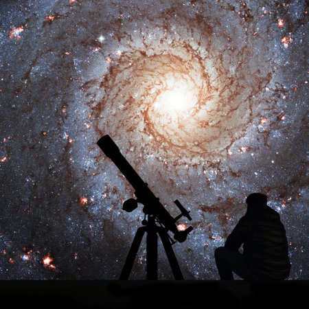 Man with telescope looking at the stars. Messier 74,  NGC 628 Spiral galaxy in the constellation Pisces.Elements of this image are furnished by NASA.の写真素材