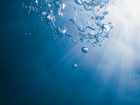 Underwater bubbles with sunlight. Underwater background bubbles.の写真素材