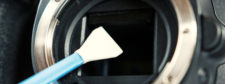 Digital photo camera with cleaning tools. Cleaning dirty camera sensor.の写真素材