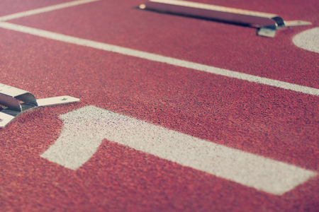 Starting line. Red running track with lane numbers. Sport Background.の写真素材