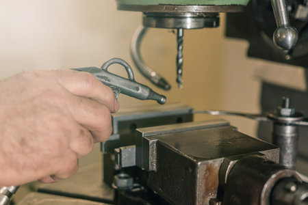 Employee drilling. Metal drilling. Metal workshop.