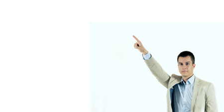 Young Businessman pointing copy space. Handsome young man  looking at camera and pointing away white backgroundの写真素材