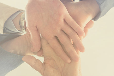Close up bottom view business people putting their hands together. Arms consolidation, Teamwork...