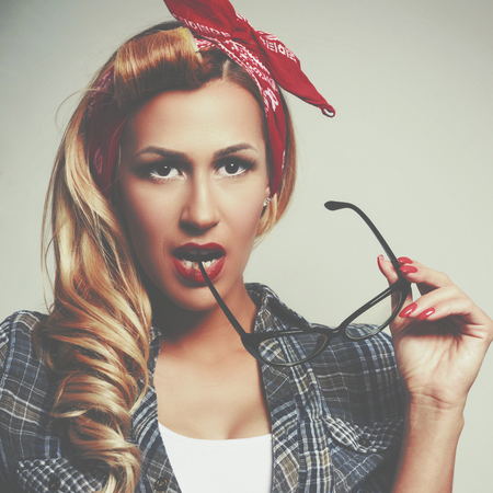 Beautiful young woman pin-up make-up and hairstyle posingの写真素材