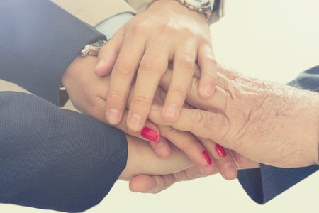 Business people putting their hands together. Arms consolidation, Teamwork concept.