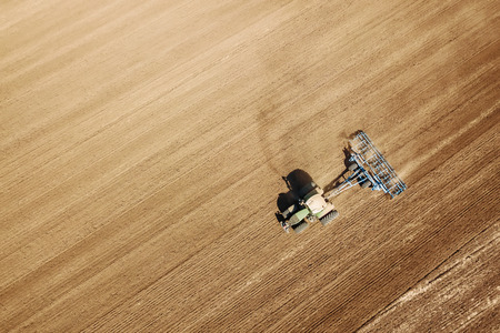 Aerial view Tractor preparing field, Agriculture tractor landscapeの写真素材