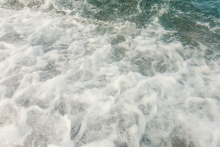 Wave of blue ocean on beach close up Summer Background