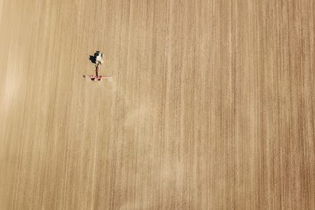 Aerial view Tractor preparing field, Agriculture tractor landscapeの写真素材
