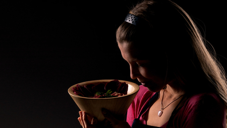 Female holding raw vegan healthy food. Raw food concept  bamboo bowlの写真素材
