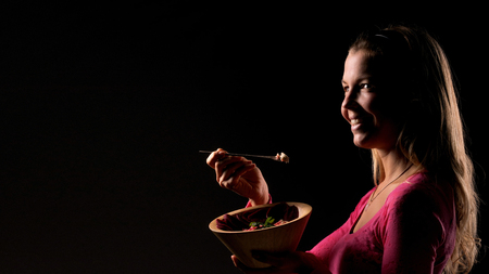 Female eat raw vegan healthy food. Raw food concept  bamboo bowlの写真素材
