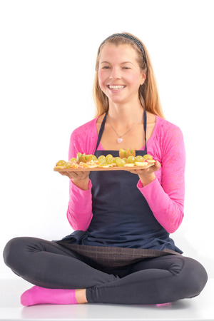 Happy Young woman holding Healthy raw vegan breakfast fresh fruit.の写真素材