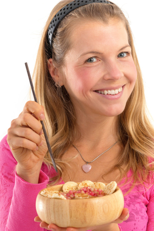 Young woman holding raw vegan healthy food. Raw food concept  bamboo bowlの写真素材