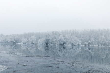 Frozen lake in winter, Winter lake scene reflecting in the waterの写真素材