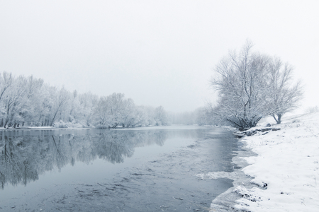 Winter lake scene reflecting in the waterの写真素材