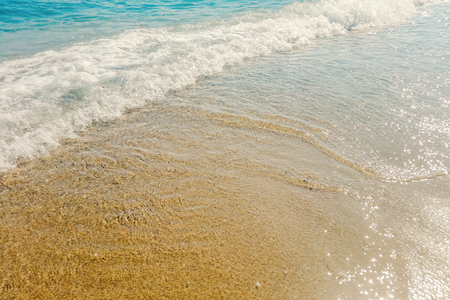 Wave of blue ocean on sandy beach close up Summer Backgroundの写真素材