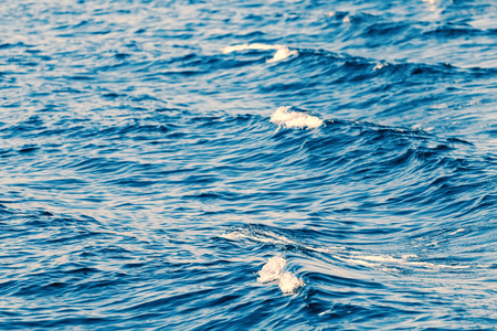 Waves behind a boat, Patterns of waves in water.の写真素材