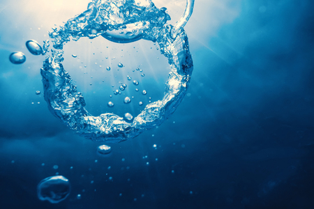 Bubble ring Underwater ascends towards the sun.の写真素材