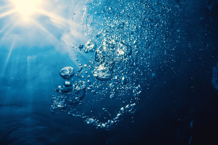 Underwater bubbles with sunlight. Underwater background bubbles.の写真素材