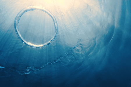 Bubble ring Underwater ascends towards the sun.の写真素材