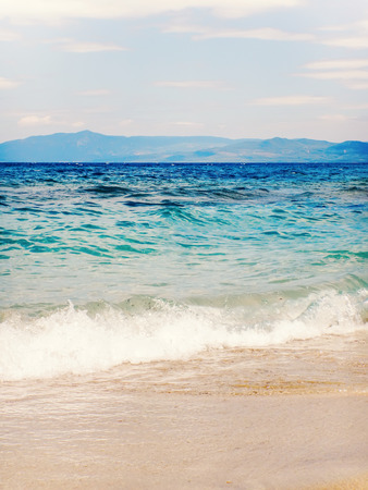 Wave of blue ocean on sandy beach Summer Backgroundの写真素材