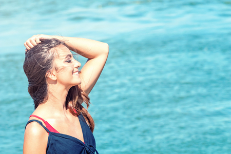 Beautiful woman on tropical beach, Brunette tanned girl enjoying and walking on beachの写真素材