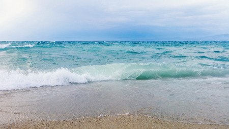 Strong waves crash over the beach Beautiful seascape.の写真素材