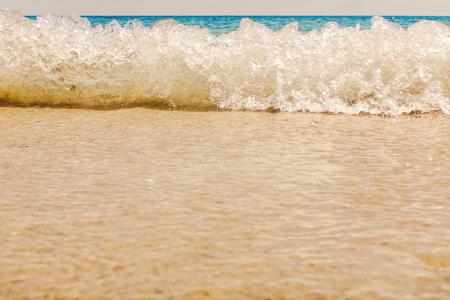 Wave of blue ocean on sandy beach Summer Backgroundの写真素材