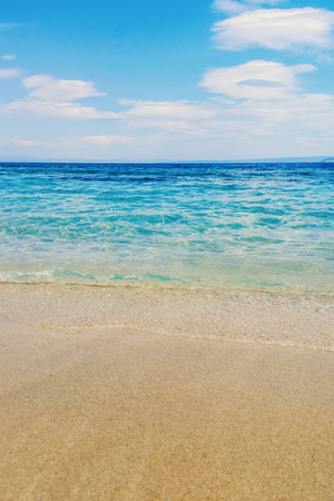 Wave of blue ocean on sandy beach Summer Backgroundの写真素材