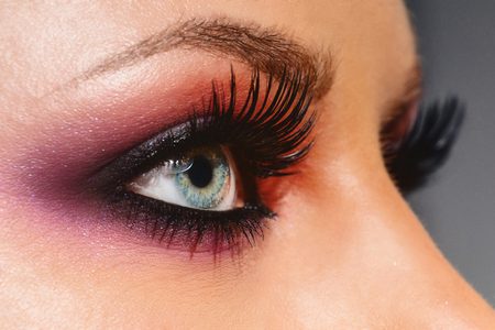 Cosmetics & make-up. Close up woman eye with beautiful shades smokey eyes makeup. Modern fashion make up.の写真素材