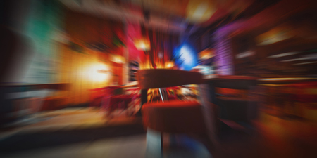Blurred cafe restaurant background night time, modern Coffee shop blur background with colorful bokehの写真素材