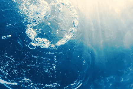 Underwater bubbles with sunlight. Underwater background bubbles.の写真素材